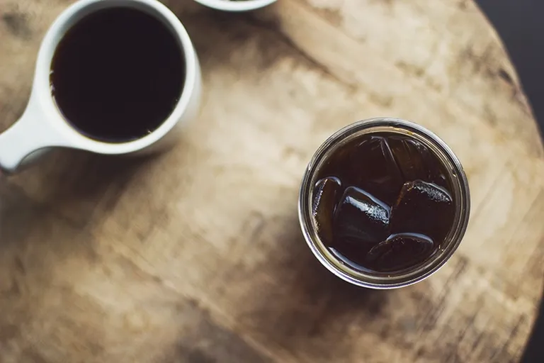 cold brew and hot brewed coffee on the table jumpstory