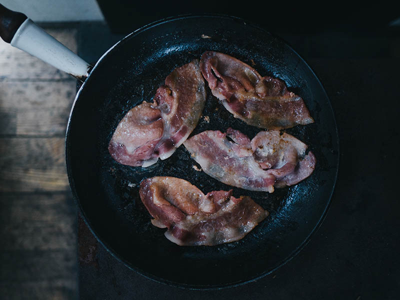 cooking bacon on skillet pan
