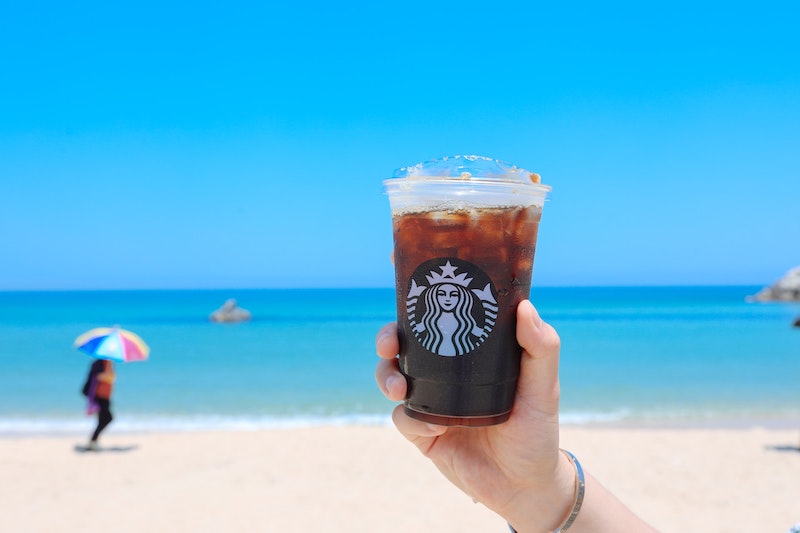 Starbucks caramel iced coffee on the beach