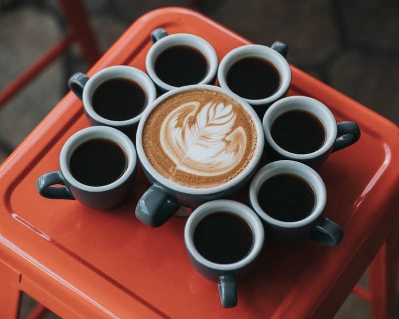 black coffee and latte art on coffee shop stool