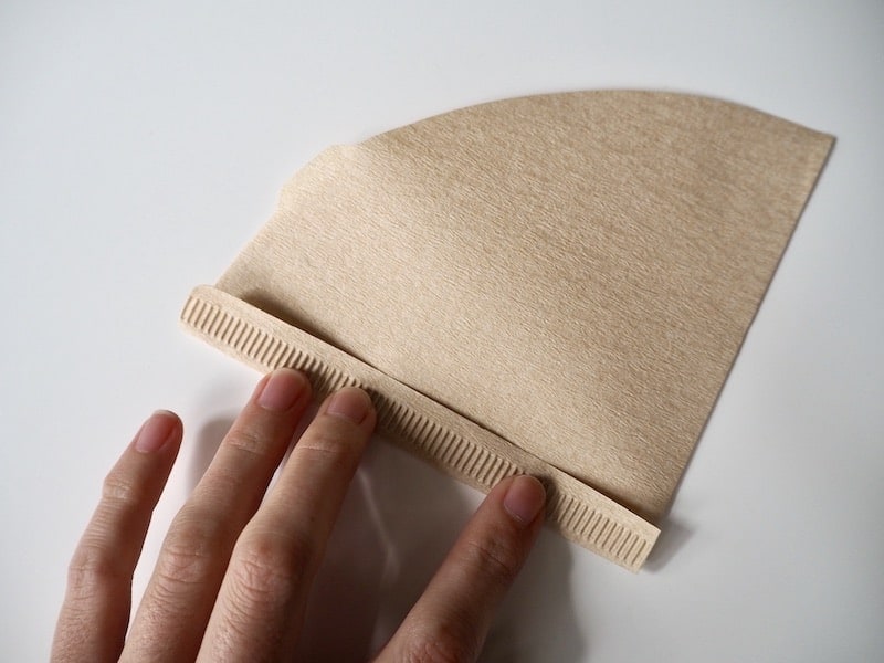 folding a brown Hario V60 paper filter