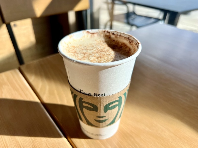 Starbucks hot mocha latte in paper cup on cafe table