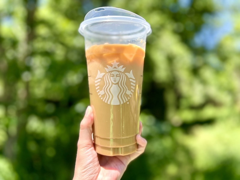 Starbucks venti iced Americano drink in hand
