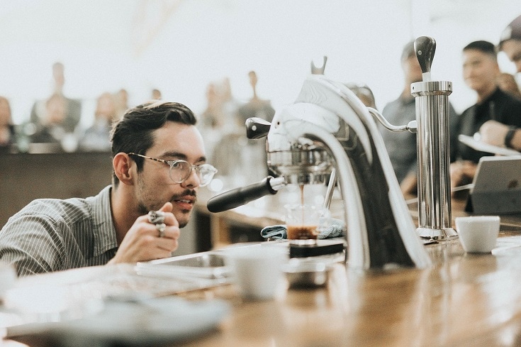 barista looking at dripping coffee