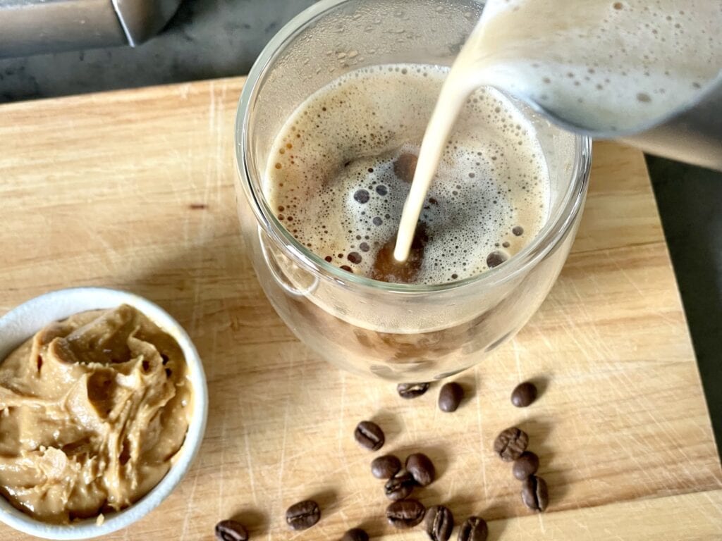 pouring peanut butter milk mixture over coffee