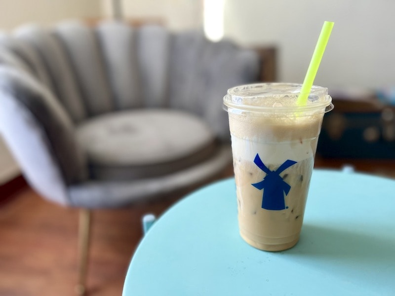 Dutch Bros breve coffee drink with soft top on table