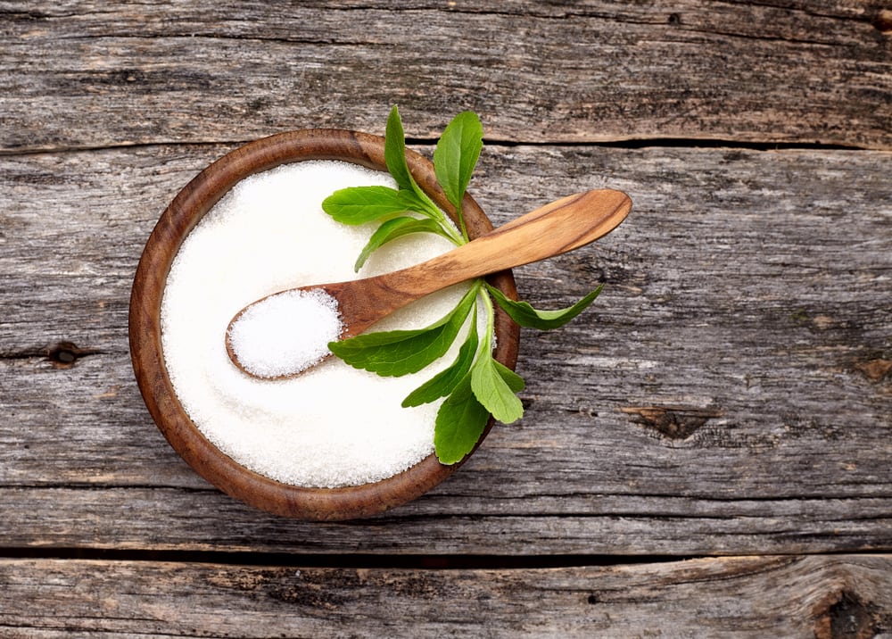 Stevia rebaudiana in a wooden bowl