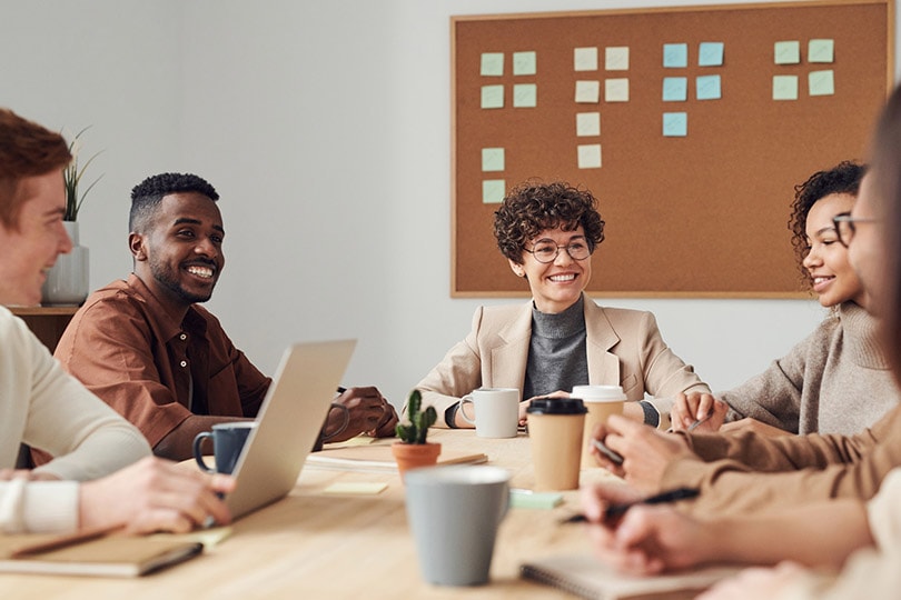 photo of people in a meeting drinking coffee