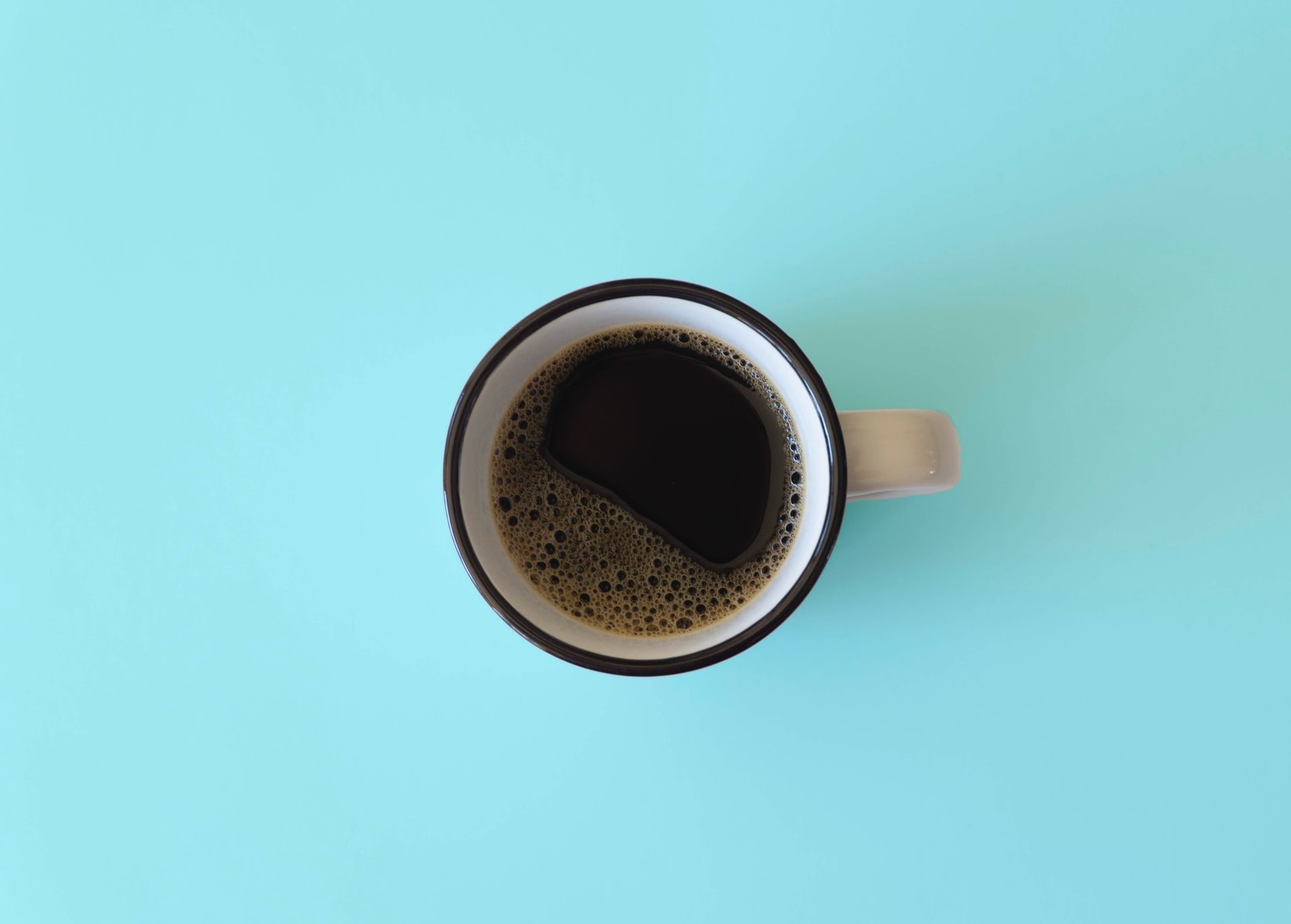 cup of hot coffee in blue background