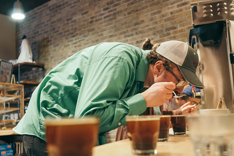 a man with a cap at a coffee tasting event