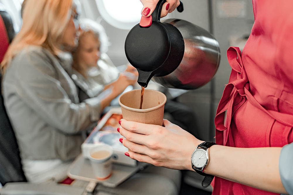 stewardess preparing airplane coffee