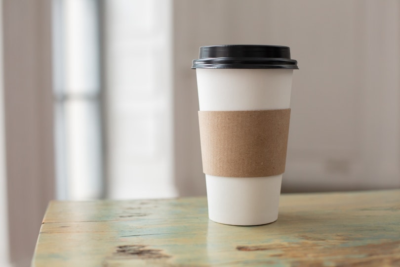 coffee paper cup with holder on a table