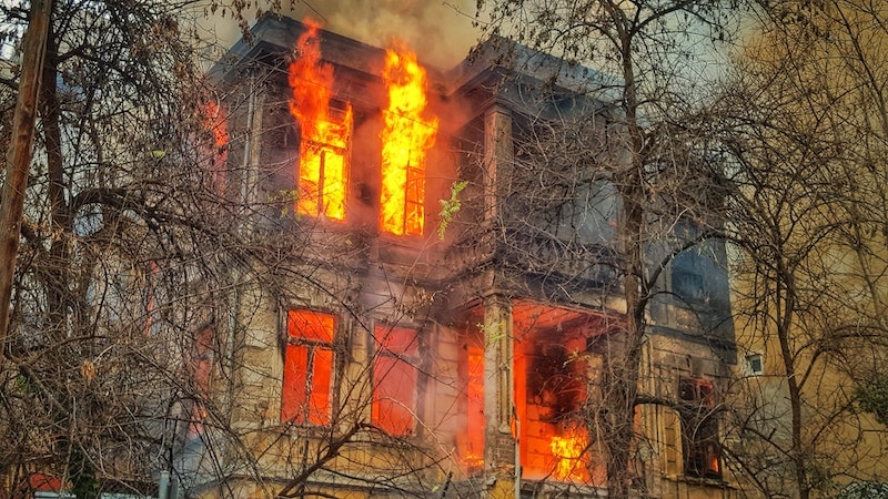 house on fire with trees