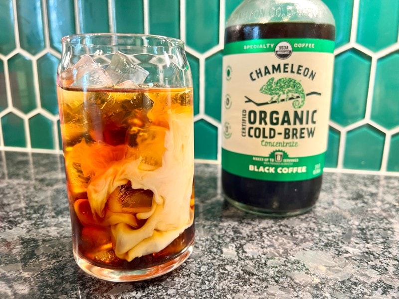 Chameleon cold brew concentrate in bottle and glass with half and half cream