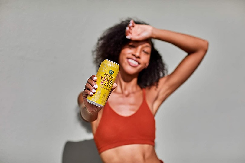 woman holding Guayakí Yerba Mate Energy Drink