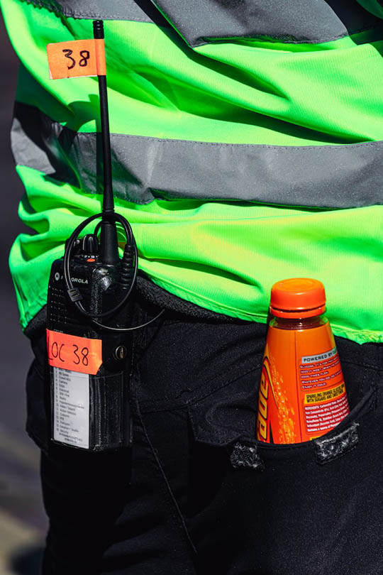 a bottle of lucozade on a person's pocket