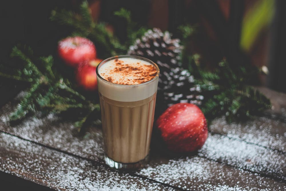 a glass of coffee with powdered sugar