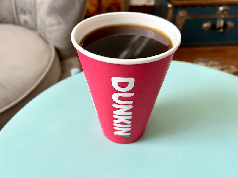 dunkin donuts regular black coffee in red paper cup