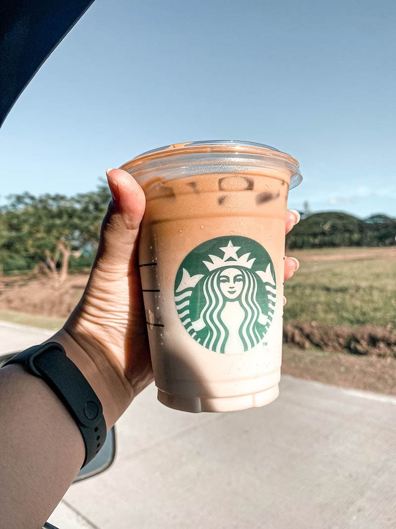 hand holding Starbucks Iced Caramel Macchiato