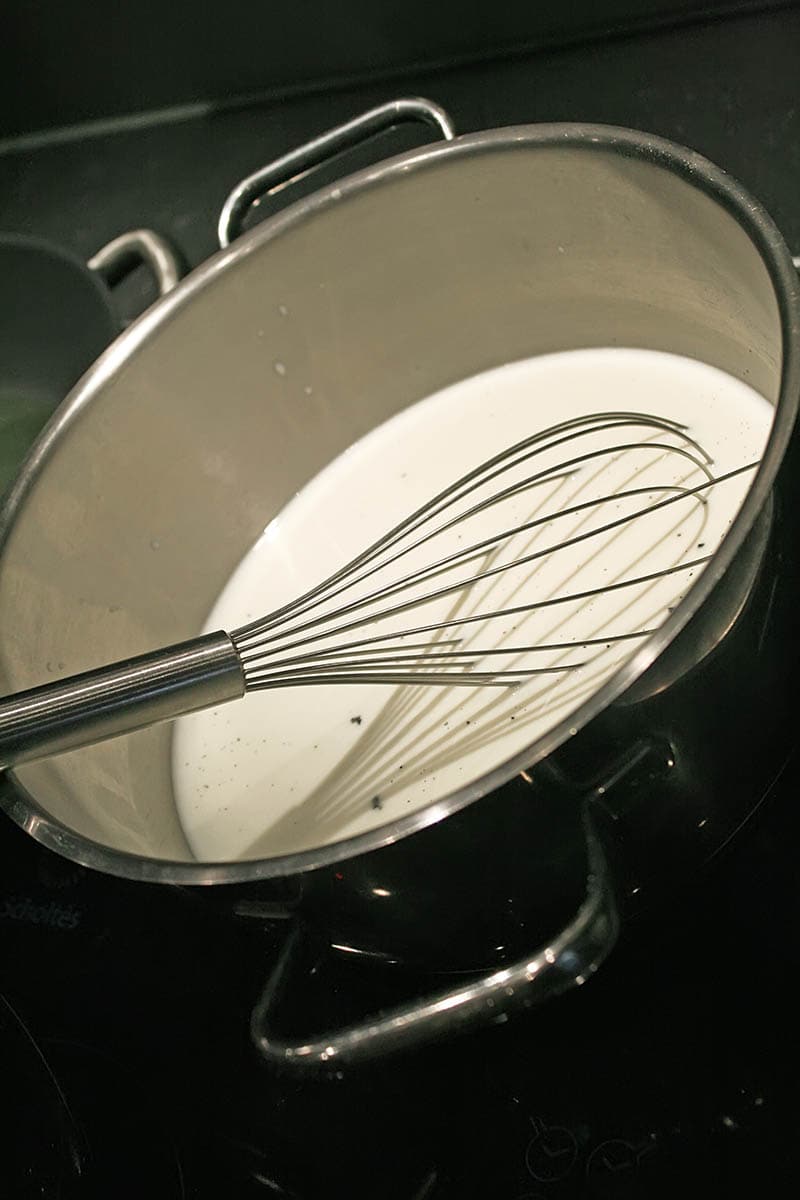 milk and whisk in a stove pot