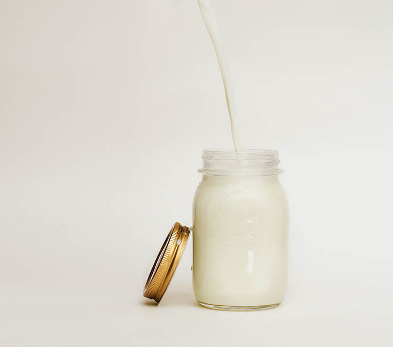 pouring milk on mason jar