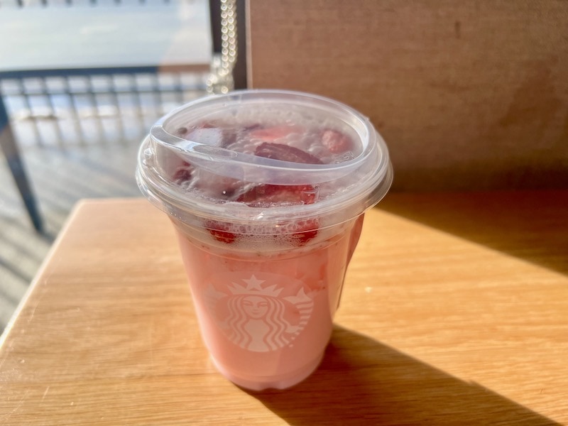 Starbucks Pink Drink with strawberries on table