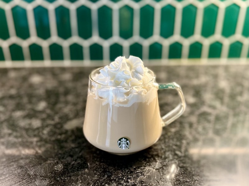 Starbucks hot drink in glass with whipped cream