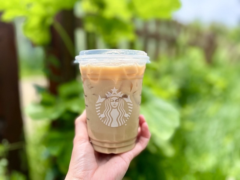 Starbucks iced chai tea latte in hand outside