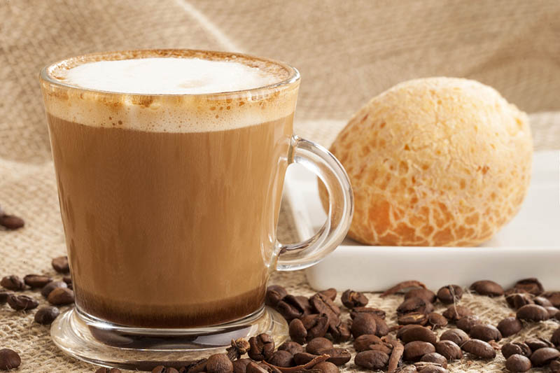 cup of latte with pastry on the side