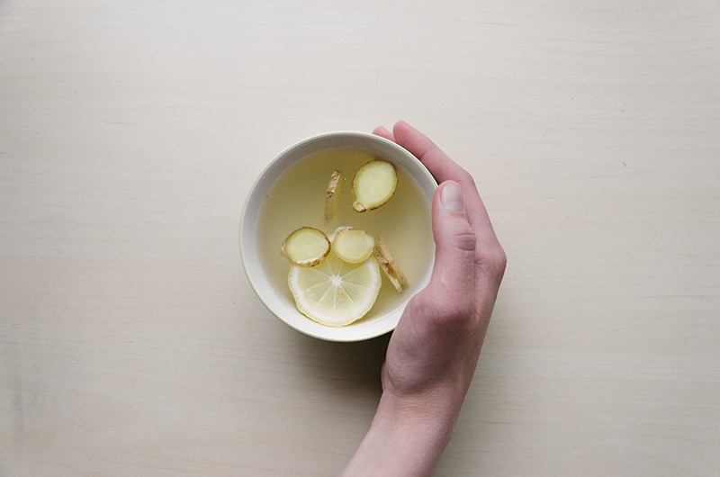 hand holding a cup of ginger tea
