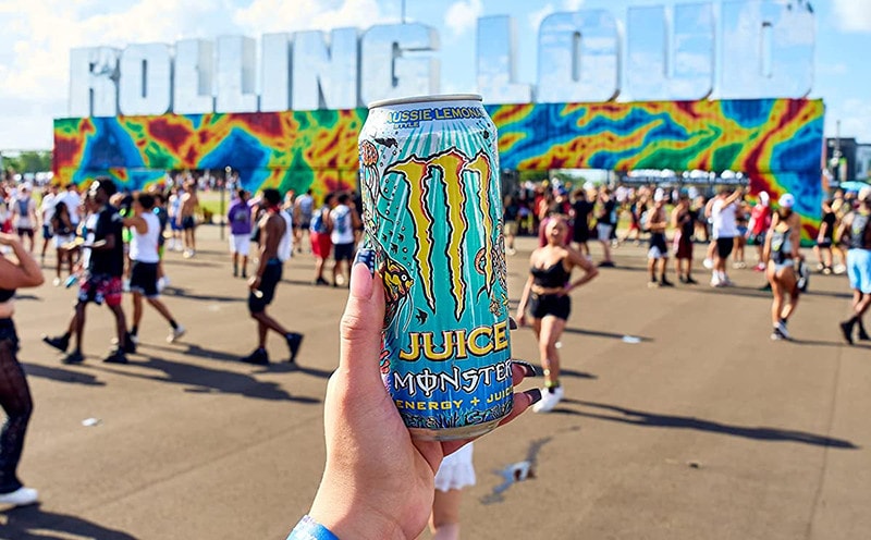 hand holding juice monster in can