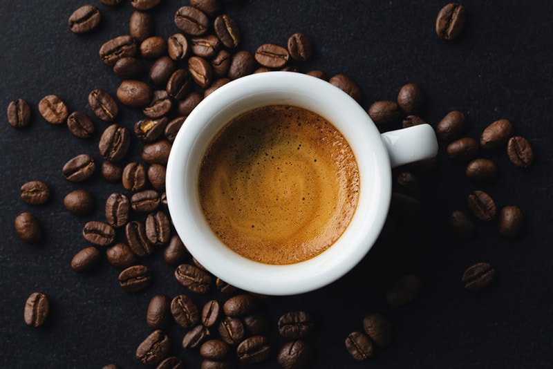espresso in a cup and coffee beans